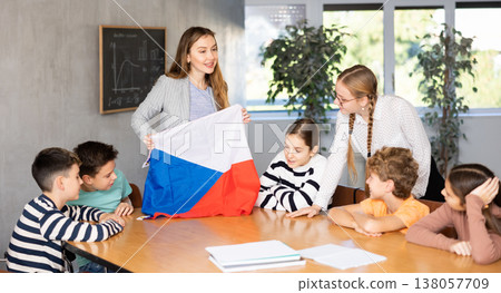Teacher showing Czech flag to group of schoolchildren Teacher showing Czech flag to group of schoolchildren 138057709