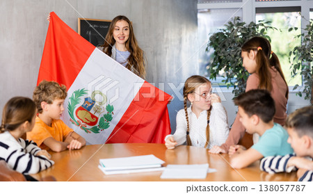 Teacher showing Peru flag to group of schoolchildren Teacher showing Peru flag to group of schoolchildren 138057787