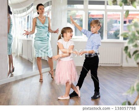 Boy and girl in pair train to dance contemporary vigorous waltz during classes. 138057798