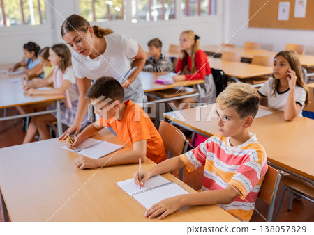 Boys studying in classroom in school Boys studying in classroom in school 138057829