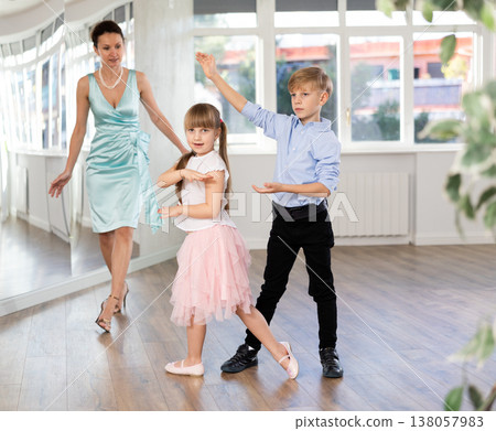 Boy and girl in pair train to dance contemporary vigorous hustle during classes. Boy and girl in pair train to dance contemporary vigorous hustle during classes. 138057983