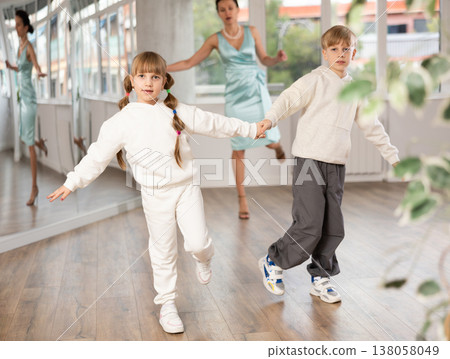 Boy and girl train to dance contemporary vigorous boogie woogie during classes. Boy and girl train to dance contemporary vigorous boogie woogie during classes. 138058049