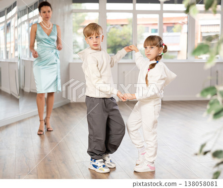 Boy and girl in sport wear train to dance contemporary vigorous rumba during classes. Boy and girl in sport wear train to dance contemporary vigorous rumba during classes. 138058081