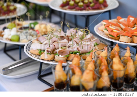 Assorted catering appetizer with shrimp tempura glass shot and meat bruschetta on buffet table for event decoration with no people and copy space 138058157