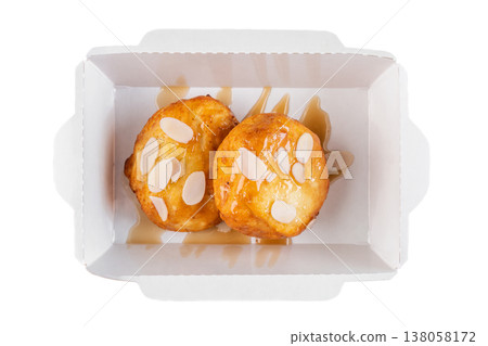 Sweet cottage cheese pancake with syrup and almond flake in craft paper take out box top view close up flat lay delicious dessert breakfast snack 138058172