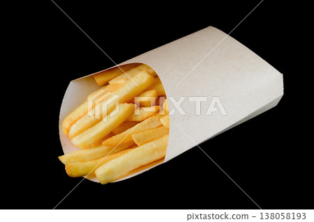 Crispy golden french fry in craft paper pocket on black background side view close up with copy space delicious savory junk food snack for menu Crispy golden french fry in craft paper pocket on black background side view close up with copy space delicious savory junk food snack for menu 138058193
