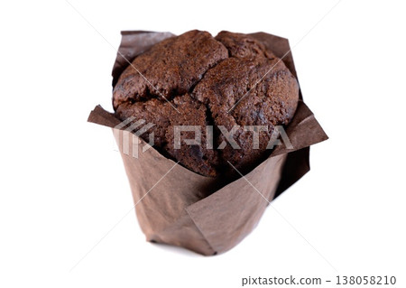 Delicious chocolate muffin in brown paper tulip liner on white background side view close up with copy space sweet bakery dessert Delicious chocolate muffin in brown paper tulip liner on white background side view close up with copy space sweet bakery dessert 138058210