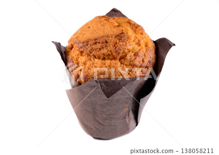Delicious sweet muffin in brown paper tulip liner on white background side view close up with copy space bakery dessert for menu Delicious sweet muffin in brown paper tulip liner on white background side view close up with copy space bakery dessert for menu 138058211