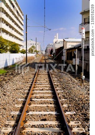 The Wadamisaki Line tracks stretch straight ahead in the quiet of the daytime. The Wadamisaki Line tracks stretch straight ahead in the quiet of the daytime. 138058289