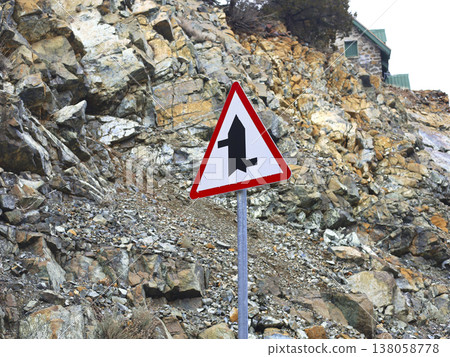 Triangular Merge Warning Sign On Rocky Road Triangular Merge Warning Sign On Rocky Road 138058778