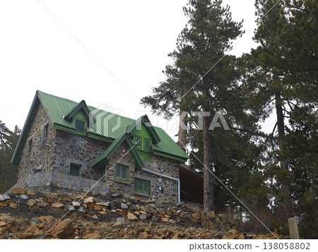 Stone Cabin With Green Roof Among Pines Stone Cabin With Green Roof Among Pines 138058802
