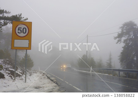 Foggy Mountain Road With Speed Sign 138058822