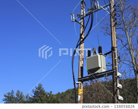 Utility pole transformer against clear blue sky 138058826