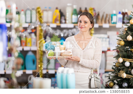 Young woman buyer chooses cosmetics gift set for christmas Young woman buyer chooses cosmetics gift set for christmas 138058835