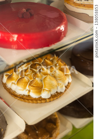 Closeup of various delicious sweet cakes and pastries displayed in bakery display case Closeup of various delicious sweet cakes and pastries displayed in bakery display case 138058853