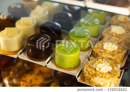 Display case displays cakes, cupcakes Display case displays cakes, cupcakes 138058882
