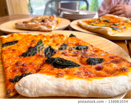 Freshly baked Margherita pizza with cheese and basil Freshly baked Margherita pizza with cheese and basil 138061034