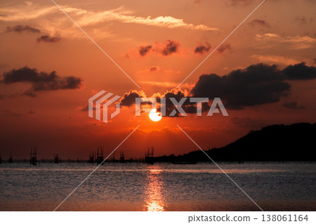 Golden Sunset over Songkhla Lake: Fish Cages and Mountain Silhouettes at Suan Pa Prem Golden Sunset over Songkhla Lake: Fish Cages and Mountain Silhouettes at Suan Pa Prem 138061164