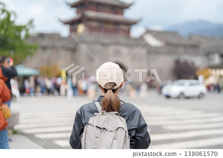 Happy woman traveler travel in Dujiangyan city. Tourist sightseeing Guanxian Ancient City near Chengdu. Landmark and popular for tourism attraction in Sichuan, China 138061570