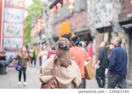 Happy woman traveler travel in Chengdu city. Tourist sightseeing and shopping in Jinli Ancient Street. Famous Landmark for tourism attraction in Sichuan, China 138061584