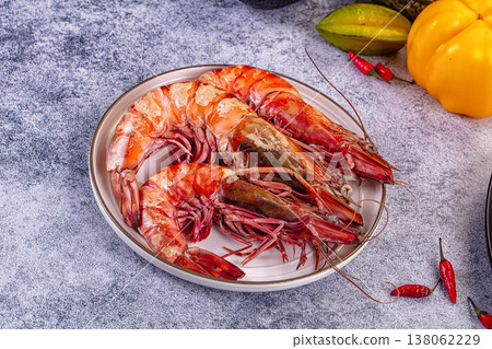 Grilled giant red prawns in a pan with fresh avocado, bell pepper, and salad on a stone table Grilled giant red prawns in a pan with fresh avocado, bell pepper, and salad on a stone table 138062229
