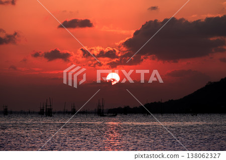 Golden Sunset over Songkhla Lake: Fish Cages and Mountain Silhouettes at Suan Pa Prem Golden Sunset over Songkhla Lake: Fish Cages and Mountain Silhouettes at Suan Pa Prem 138062327