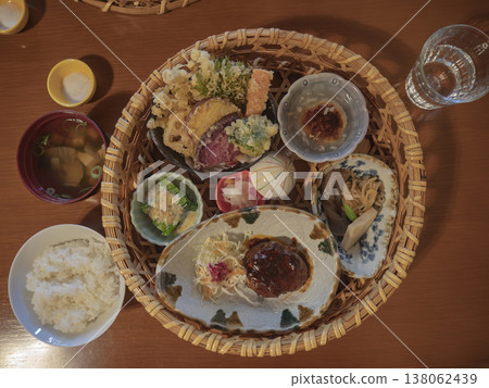 A luxurious and relaxing experience: a beautifully arranged Japanese set meal in a bamboo basket. A luxurious and relaxing experience: a beautifully arranged Japanese set meal in a bamboo basket. 138062439