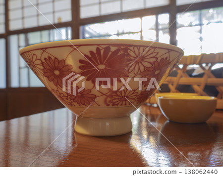 Chrysanthemum pattern translucent in the sunlight, a stylish piece of tableware from a renovated old house cafe. Chrysanthemum pattern translucent in the sunlight, a stylish piece of tableware from a renovated old house cafe. 138062440