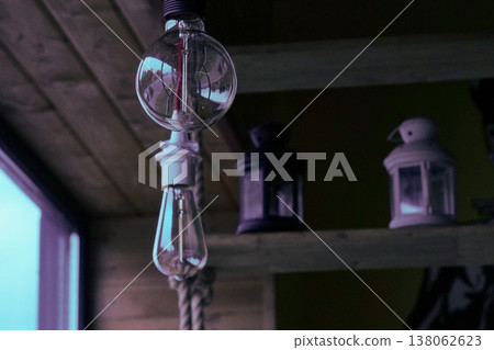 Vintage light bulbs suspended from a wire. Hanging retro incandescent lamps.  closeup of photo          138062623