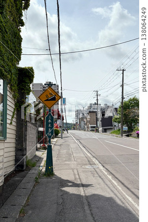 A vertical composition of the streetscape and sloping streets of Otaru, Hokkaido in early summer. A vertical composition of the streetscape and sloping streets of Otaru, Hokkaido in early summer. 138064249