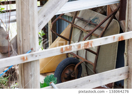An old shed and a wheelbarrow An old shed and a wheelbarrow 138064276