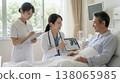 A female doctor talking to a hospitalized patient in their room. 138065985