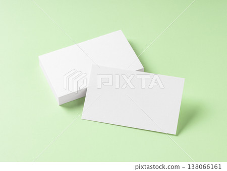 A mockup of a pure white business card placed on a light green background. A mockup of a pure white business card placed on a light green background. 138066161