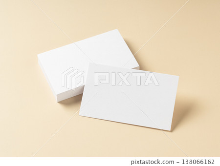 A mockup of a stack of white business cards and a card placed against a beige background. A mockup of a stack of white business cards and a card placed against a beige background. 138066162