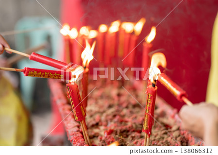 Lighting red temple candles Lighting red temple candles 138066312
