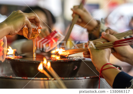Pouring oil for shrine flame Pouring oil for shrine flame 138066317