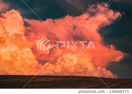 Dramatic sunset clouds over a dark rural field horizon 138066373