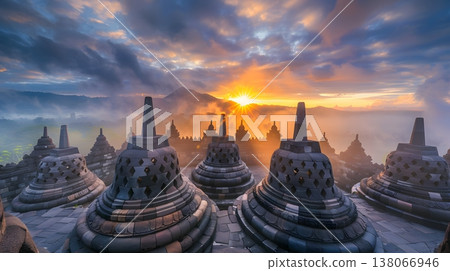 A mystical morning view of the Borobudur temple complex shrouded in mist. A mystical morning view of the Borobudur temple complex shrouded in mist. 138066946