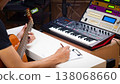 male musician writing a hit song by acoustic guitar in home studio 138068660