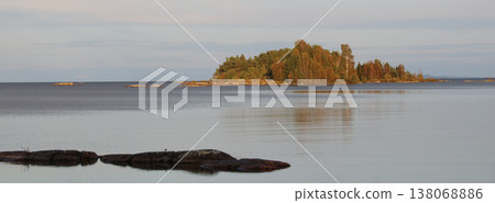Golden trees in autumn on a island in Lake Vanern, Sweden. Golden trees in autumn on a island in Lake Vanern, Sweden. 138068886