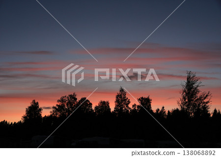 Bright lit clouds over tree tops in Mellerud, Sweden. Bright lit clouds over tree tops in Mellerud, Sweden. 138068892