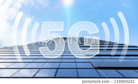 5G internet signal shown on a tall building under a blue sky with clouds 138069282