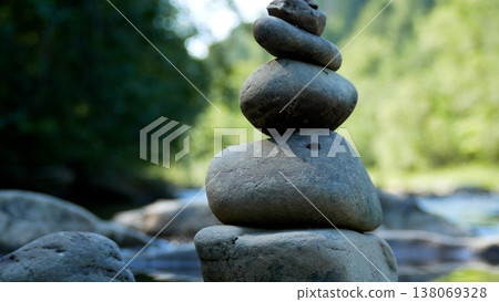 Pebbles stacked on top of each other on the river bank. 138069328