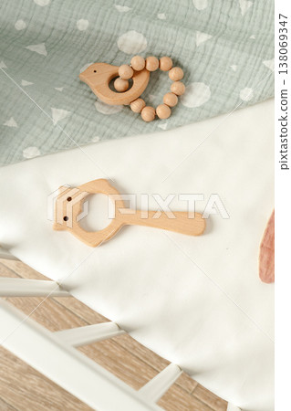Wooden toys and baby accessories on a light fabric surface in a bright room setting Wooden toys and baby accessories on a light fabric surface in a bright room setting 138069347