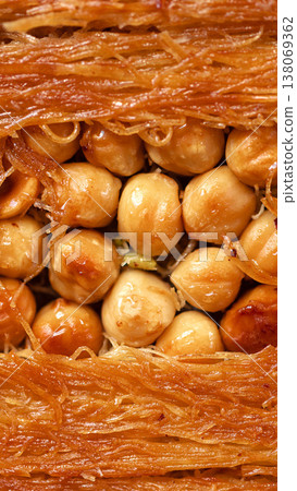 Layer of crispy dessert with nuts and sweet syrup in close view during cultural event Layer of crispy dessert with nuts and sweet syrup in close view during cultural event 138069362