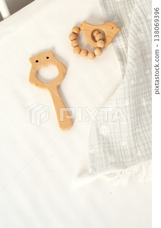 Wooden toys and a soft cloth on a light background in a nursery setting Wooden toys and a soft cloth on a light background in a nursery setting 138069396