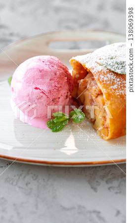 Dessert served with pink ice cream and a pastry on a plate in a bright setting Dessert served with pink ice cream and a pastry on a plate in a bright setting 138069398