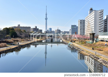 The JR Sobu Line railway bridge and Tokyo Skytree as seen from the Fureai Bridge over the Old Nakagawa River. 138069712