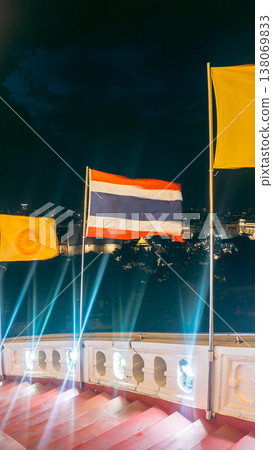 Thai flag waving over Bangkok city skyline with temples, Thailand national flag against urban panorama grand palace view Thai flag waving over Bangkok city skyline with temples, Thailand national flag against urban panorama grand palace view 138069833