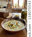 Traditional Polish Pickle Soup (Zupa Ogorkowa) Served in a Cozy Rustic Kitchen with Rye Bread and Dill 138070543